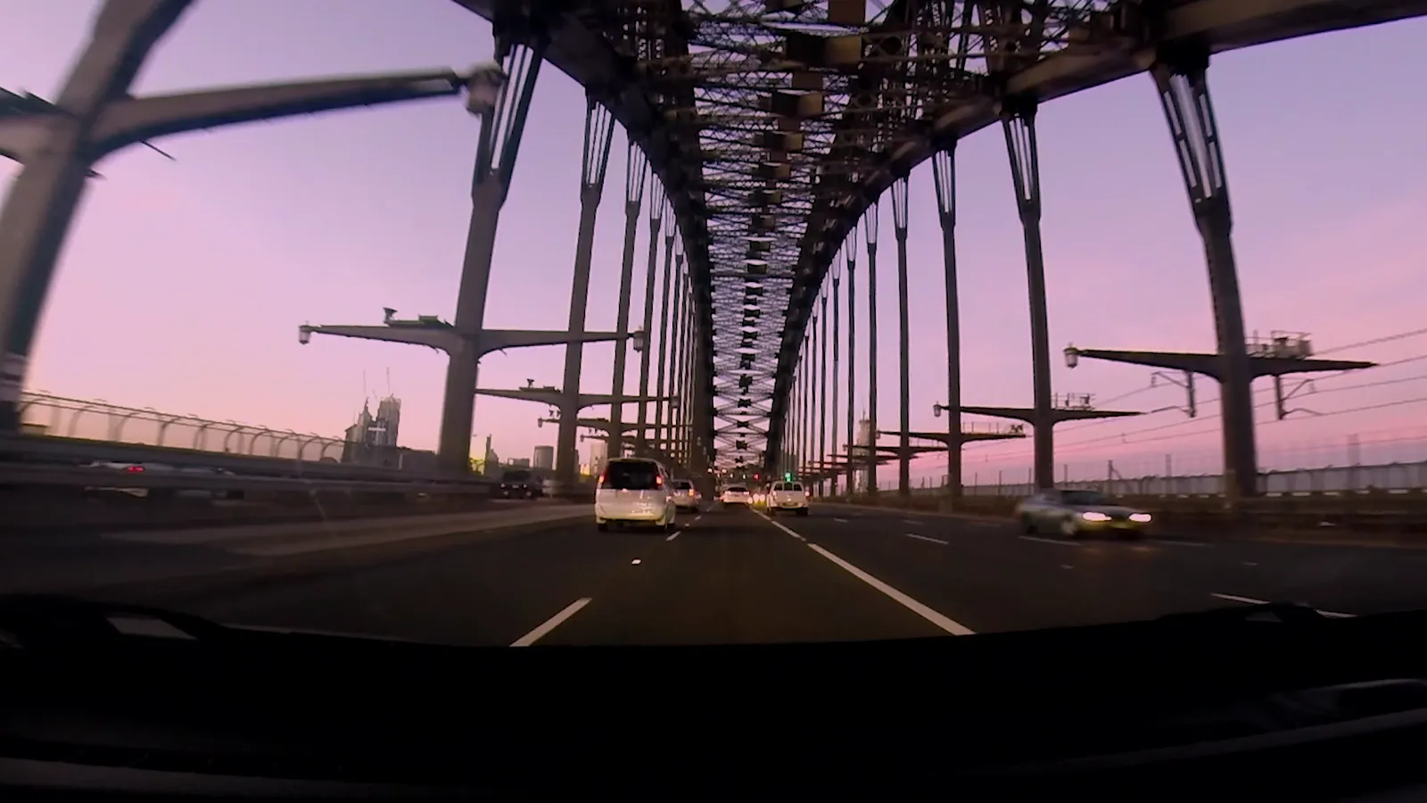 Driving across the Sydney Harbour Bridge at dusk