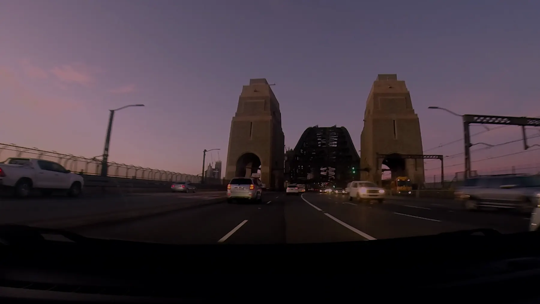 Driving across the Sydney Harbour Bridge at dusk